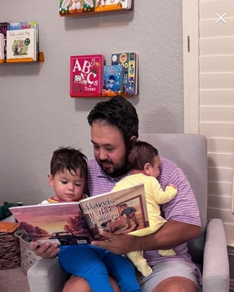 A dad reading Hands Like Daddy's with his child