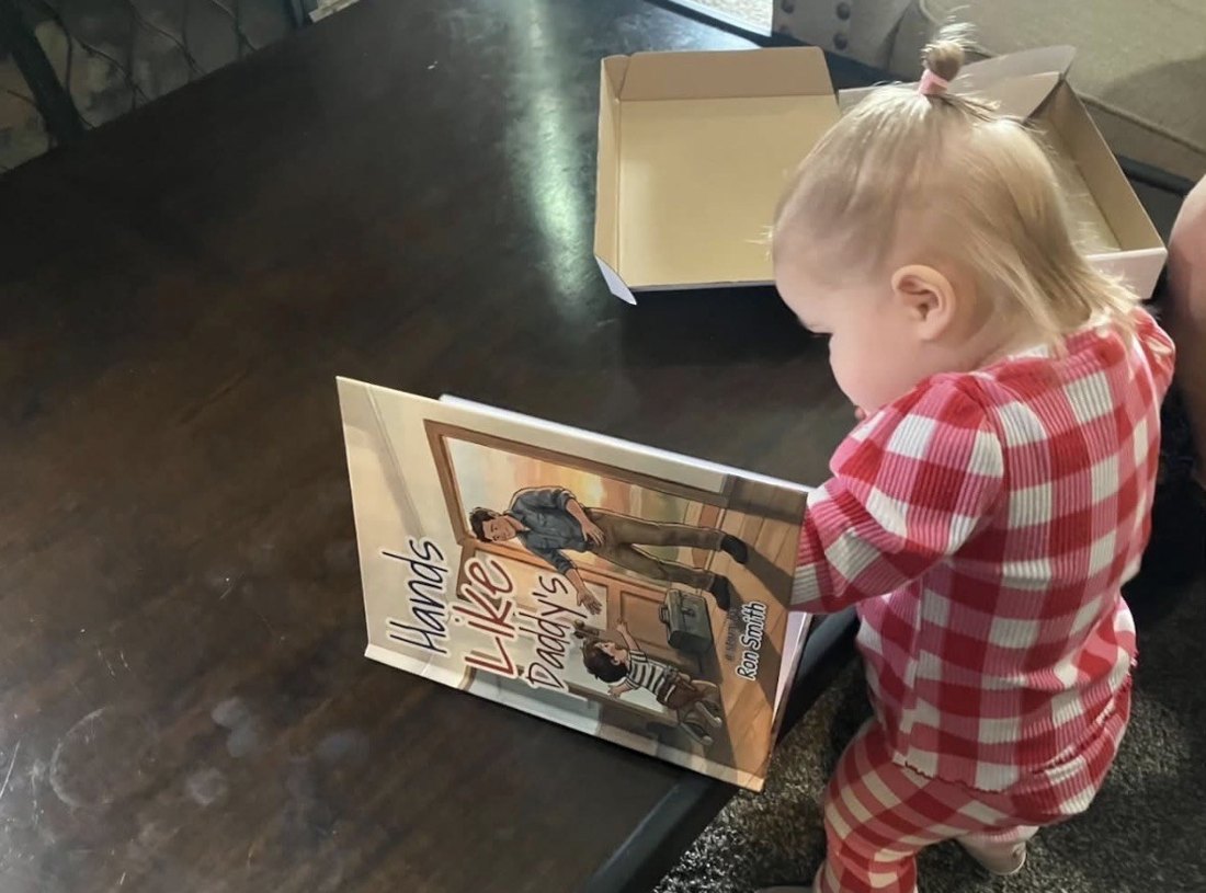 A toddler reading the hardcover the day it arrived